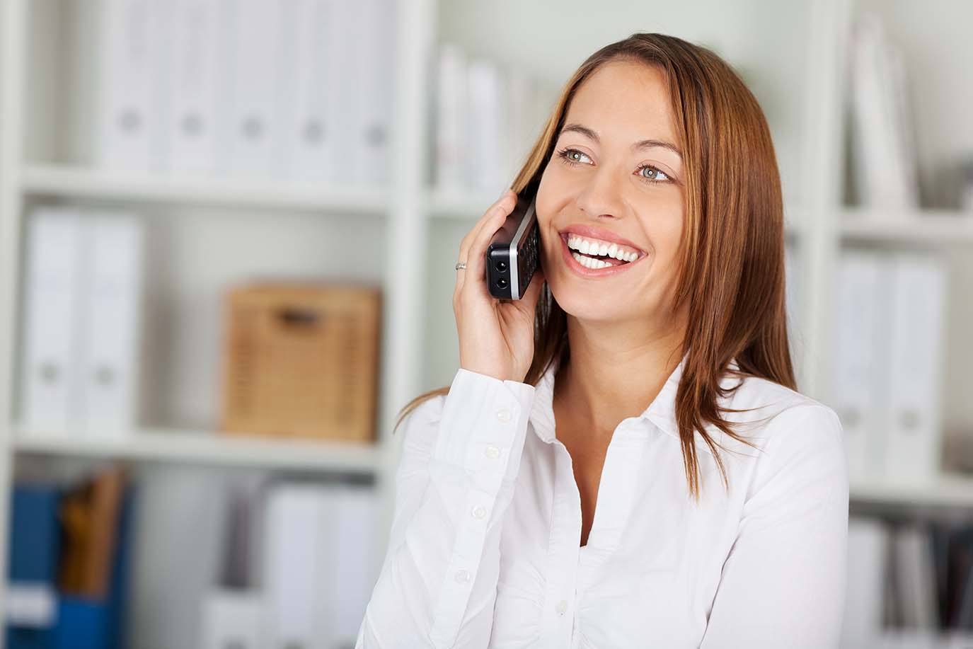 woman holding a landline phone