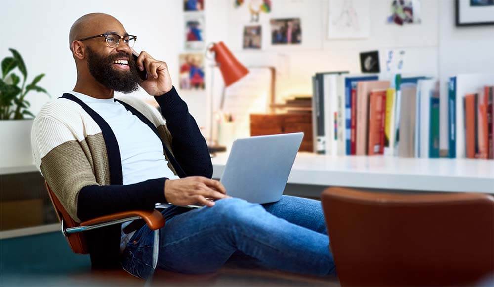 Man in home office talking on the phone_mob